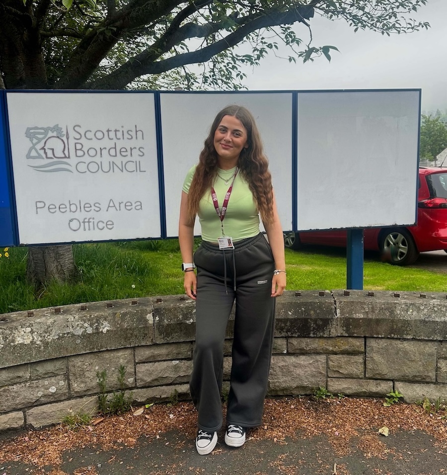 Photograph of Neve Hay standing next to a Scottish Borders Council sign