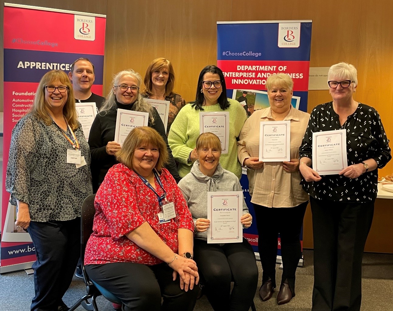 Group of candidates holding course completion certificates